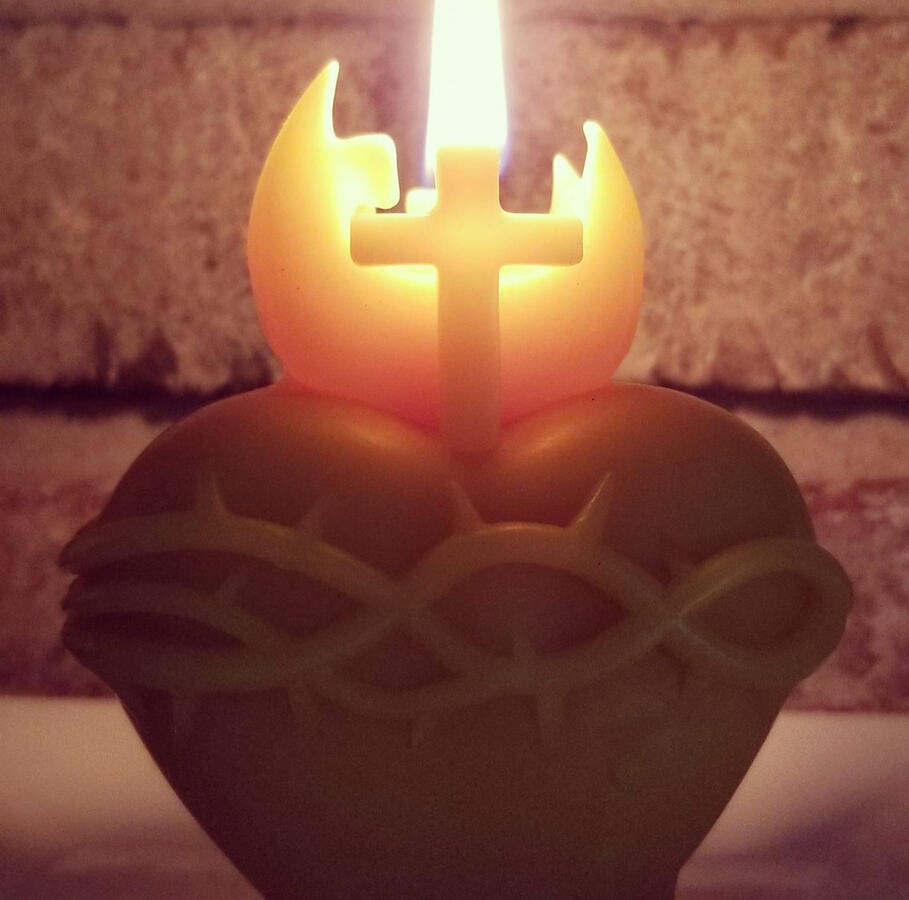 Burning Sacred Heart of Jesus candle